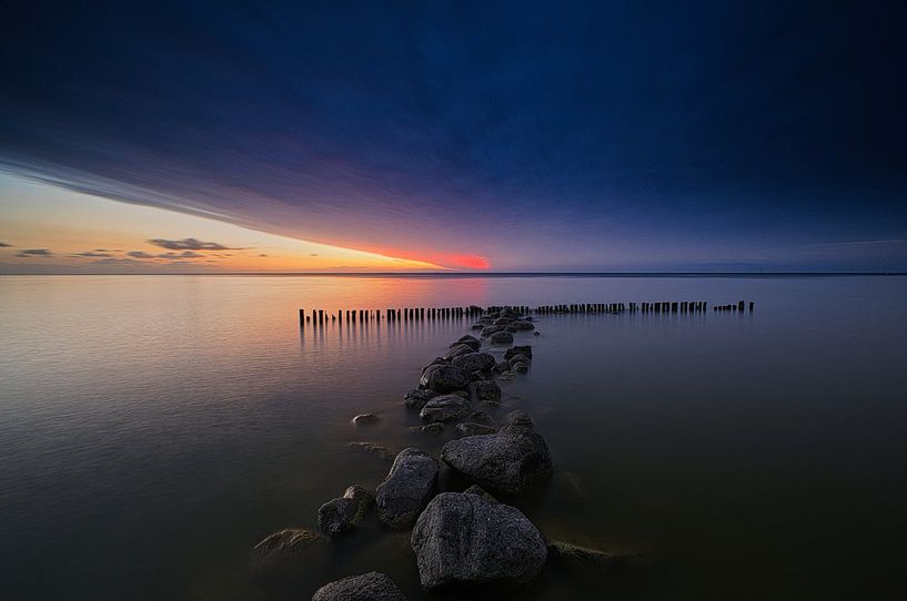 Red glow at Enkhuizen breakwater by peterheinspictures