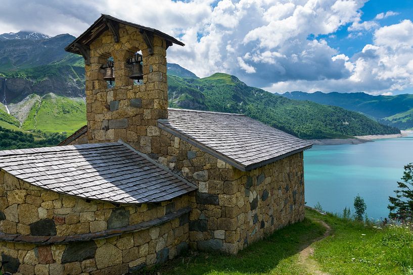 Church at a blue mountain lake in France by Linda Schouw