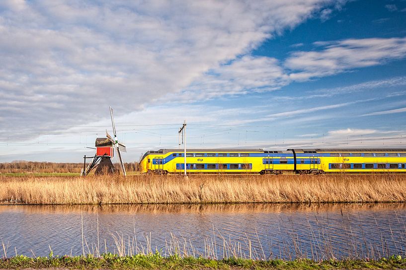 The train in the Dutch landscape: Lageveensemolen, Noordwijkerhout. by John Verbruggen