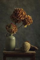 green jug with old flowers and nuts