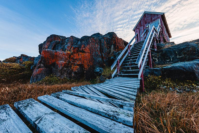 Characteristic wooden house with stairs on the Greenland rocky coast by Martijn Smeets