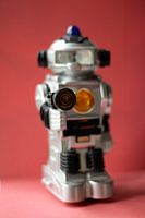 Vintage toy robot on red