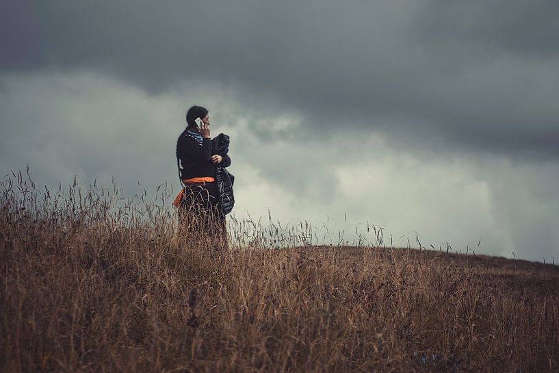Tibetan woman on the phone by Anahi Clemens
