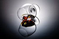 Cognac glass containing cognac and ice cubes.