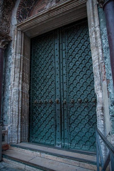 Door of the San Marco Basilica in Venice, Italy with bronze lion heads by Joost Adriaanse