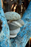 Zen pile of stones in an aqua painted tree
