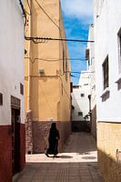 Old woman passing by in the medina of Rabat, Morocco.