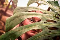 Girl looking through a leaf