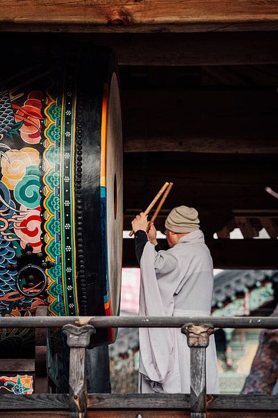 Monk with drum in Seoul by Studio Graber