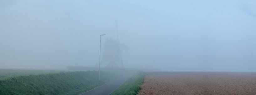 Morning fog at the mill in the field by Marcel Derweduwen