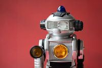 Vintage toy robot on red