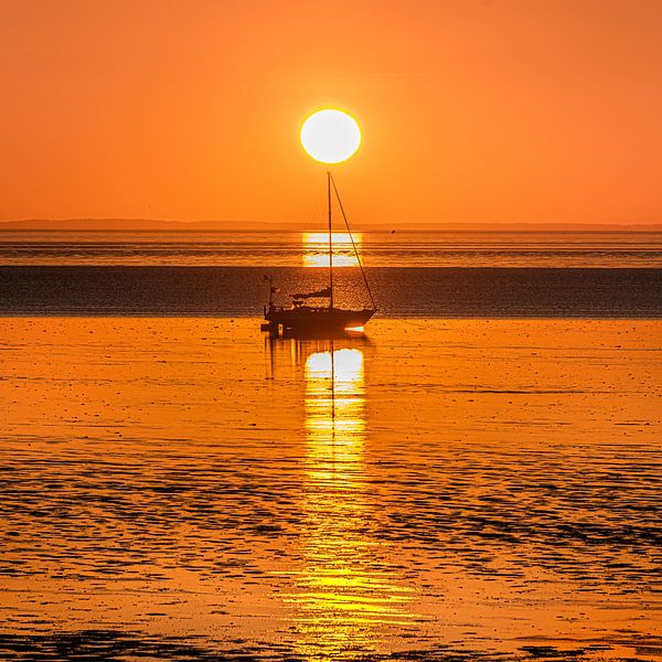 Sunset over the Frisian mud flats near Koehoal by Harrie Muis