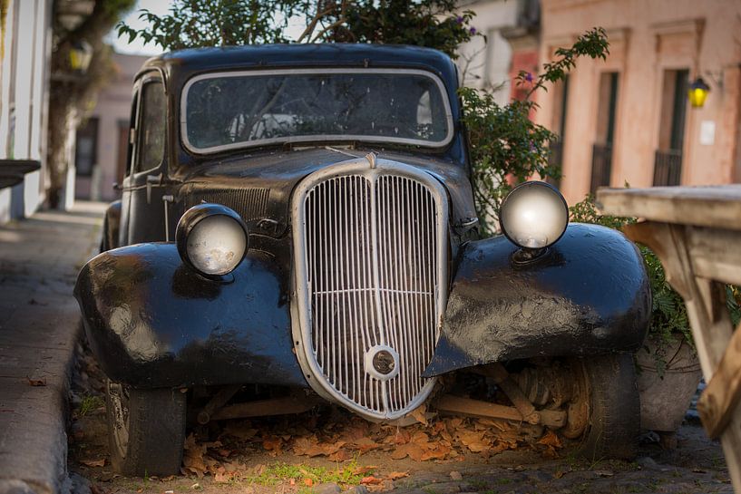 Grill and headlights of classic car after sunset by Jan van Dasler