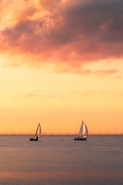Sailboats against an orange cloudy sky by Sugar_bee_photography