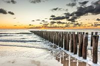 Sunset Valkenisse beach with breakwaters