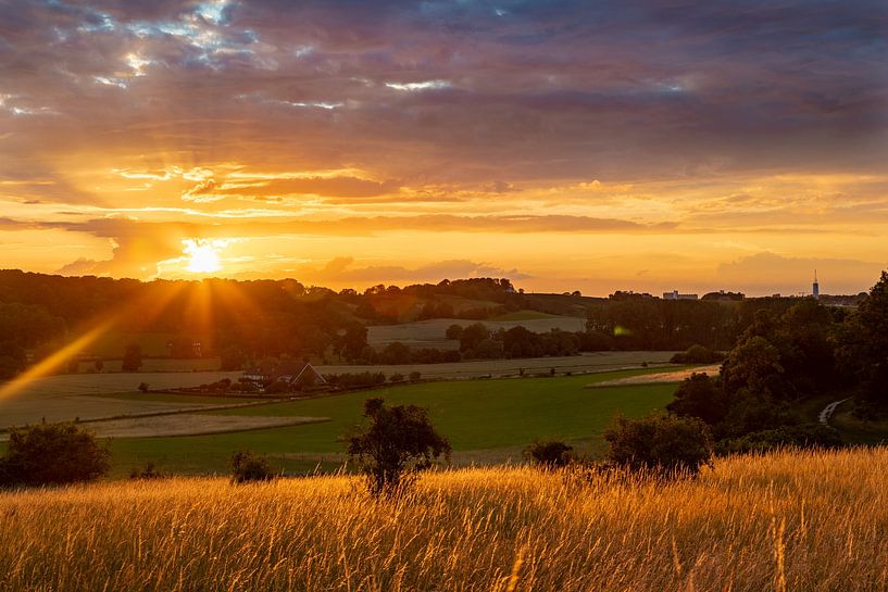 warm sunset with beautiful rays and a lovely red and yellow glow by Kim Willems