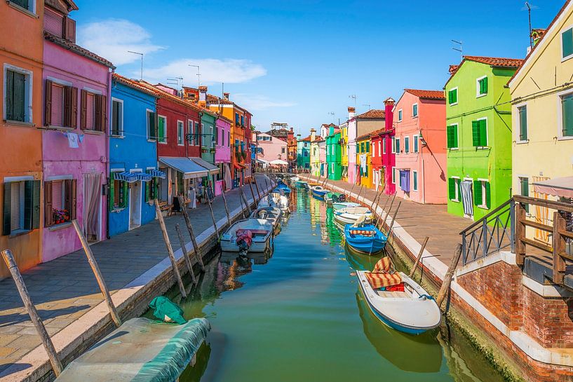 Burano island canal with colorful houses and boats by Stefano Orazzini