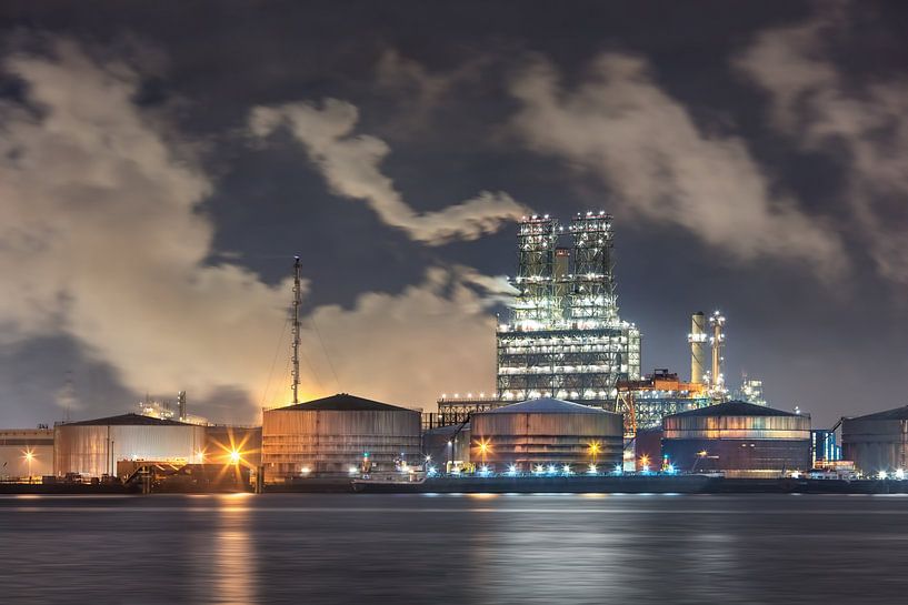 Petrochemical industry with a dramatic sky at night by Tony Vingerhoets