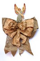 Antique Christmas angel on a bow