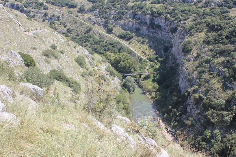 View into the Aggitis Canyon / gorge to the river and the bridge over it - Greece by ADLER & Co / Caj Kessler