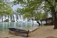 Waterfalls with a boat in the foreground near Kravica in Bosnia Herzegovina