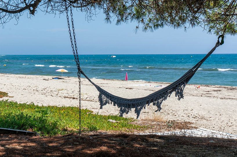 Hammock on a tropical beach on the coast of the Mediterranean island of Corsica by Animaflora PicsStock