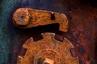 Rusted brown iron gear with emergency stop lever