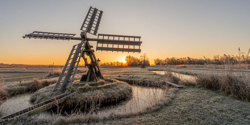 Old polder mill during sunrise. by Dafne Vos