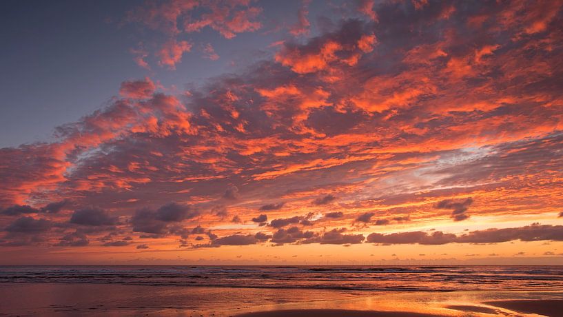 Fiery clouds at the sea by Barbara Brolsma
