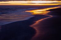 Reflektionen am Ufer bei Sonnenuntergang
