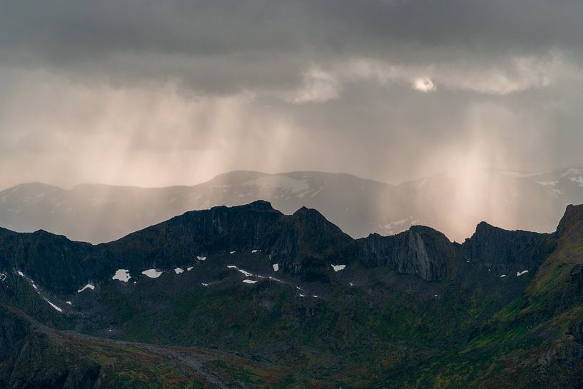 Beams of light through the rain over the mountains by Axel Weidner