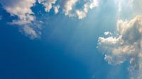 Blue sky with clouds and sun rays
