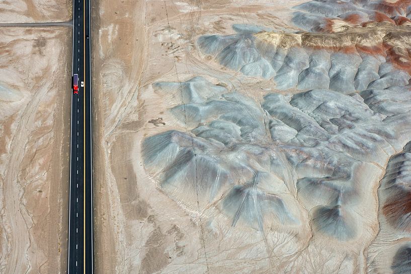 A truck drives past Badlands in the Painted Desert, Arizona, USA by Marco van Middelkoop
