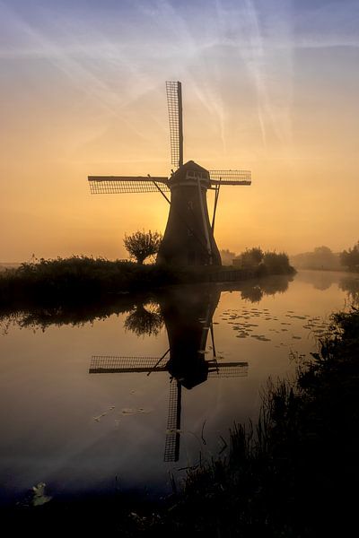 Dutch mill at a misty sunrise by Laura Wubben