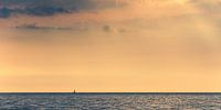 Small sailboat on wide ocean