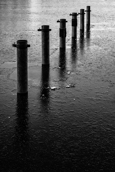 Bollard in lake by Dieter Walther