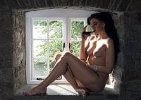 The farmer's wife, naked model posing as a pinup in a window