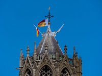 De top van de Dom in Utrecht met vlaggen van Universiteit Utrecht