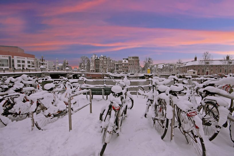 Besneeuwd Amsterdam in de winter bij zonsondergang von Eye on You