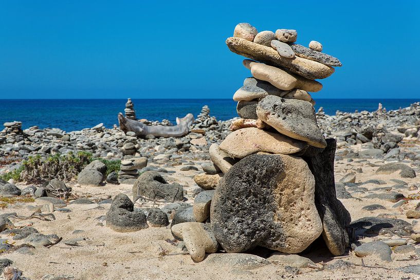 Stacked boulders as a symbol on the coast of the island of Bonaire by Ben Schonewille