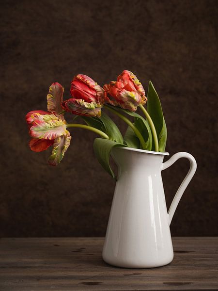 Red tulips in a vase by Lorena Cirstea