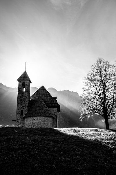 Cute little church in the mountains. Black and white photo. by Ellis Peeters