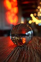 Glittering bar magic: glass ball in a sea of bokeh lights