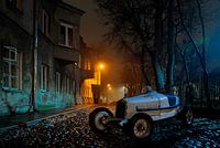 antique model car Bently in city at night