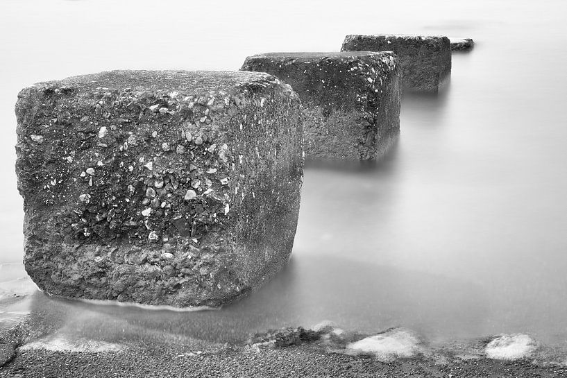 Concrete blocks leading into the sea by Jan van der Vlies