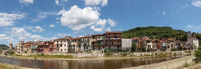 Panorma with houses along the river in Mellisimo, Piemont, Italy by Joost Adriaanse