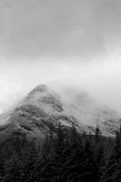 Black and white photo of fog in the snowy Scottish mountains