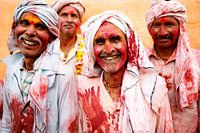 Smiling men during Holi in India.