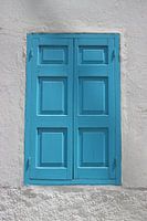 Blue window in white wall