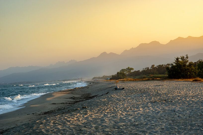 Sunrise over the mountains with fog on the coast of the Mediterranean Sea with beach island Corsica by Animaflora PicsStock